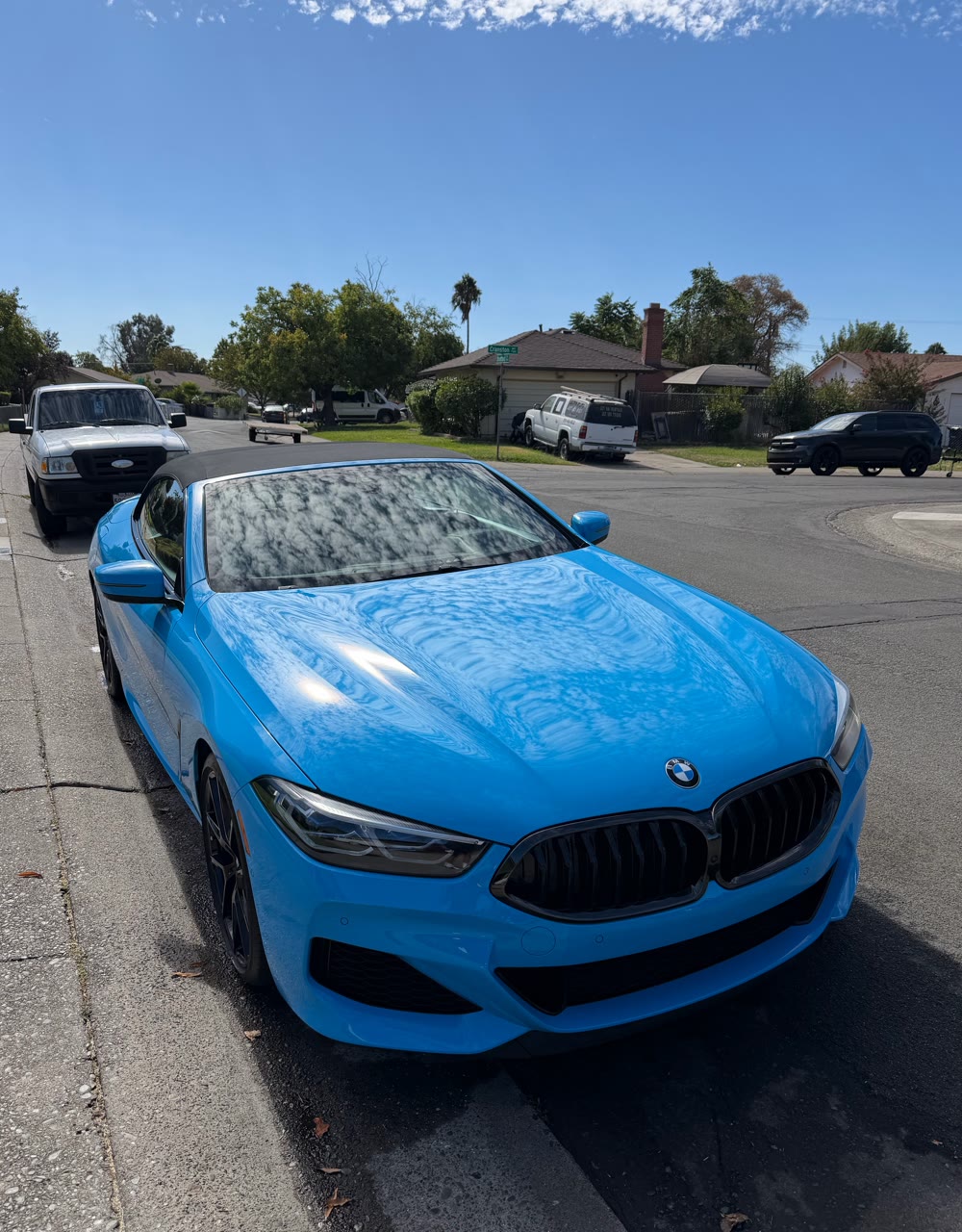 Blue BMW 8 Series convertible after exterior detail, glossy hood